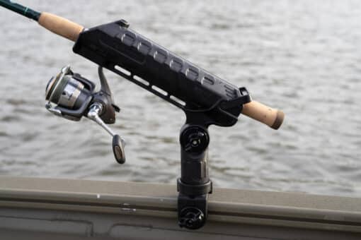 YakAttack AR Rod Tube holding a rod and reel. Attached to the gunwhale track on a fishing boat