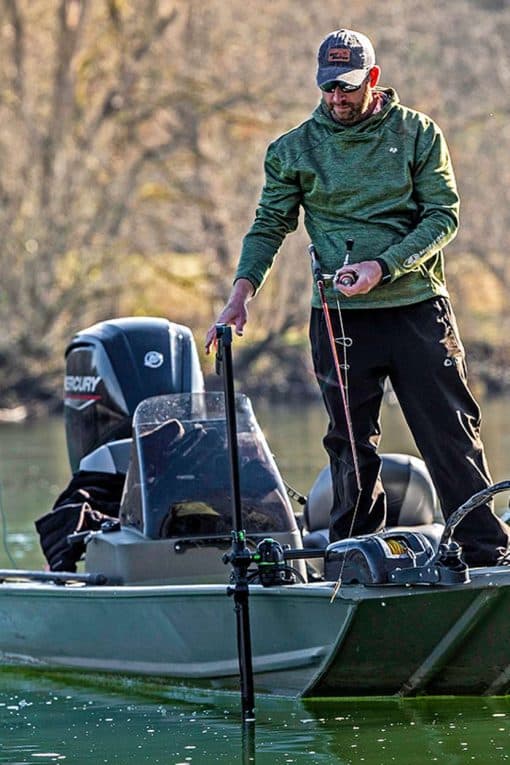 An angler using the Railblaza HEXX Live Pole 60 Transducer Mount while fishing from their small fishing boat