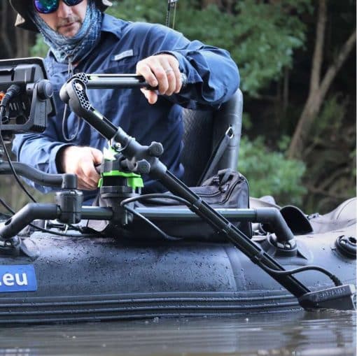An angler in the process of stowing the rail-mounted Railblaza HEXX Live Pole 30 on an inflatable boat