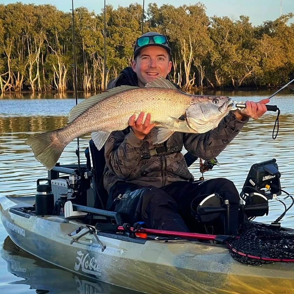 chrispyywings_fishing lands a large Jewfish from a hobie Outback Fishing Kayak